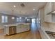 Spacious kitchen showcasing a large island with sink, stainless steel dishwasher, and modern appliances at 2767 Flowing Breeze St, Henderson, NV 89044