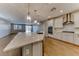 Modern kitchen with a large island, stainless steel appliances, and stylish lighting fixtures at 2767 Flowing Breeze St, Henderson, NV 89044