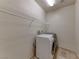 A laundry room with a front-loading washing machine and dryer sits on a tiled floor at 2767 Flowing Breeze St, Henderson, NV 89044