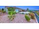 Spacious backyard with gravel landscaping, patio space, mature plants, and mountain views at 2850 Thunder Bay Ave, Henderson, NV 89052