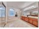 Luxurious bathroom featuring double sinks, a soaking tub, a glass block window, and a shower stall at 2850 Thunder Bay Ave, Henderson, NV 89052