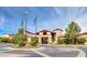 Attractive building entrance with stone accents, manicured landscaping, and flags flying under a clear, blue sky at 2850 Thunder Bay Ave, Henderson, NV 89052