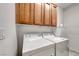 Functional laundry room with upper cabinets, a washer, and a dryer at 2850 Thunder Bay Ave, Henderson, NV 89052