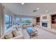 Bright living area with tile floors, fireplace, comfortable sofas, and expansive windows with view at 2850 Thunder Bay Ave, Henderson, NV 89052