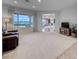 Spacious living room featuring plush carpeting, large windows, and neutral wall colors at 2850 Thunder Bay Ave, Henderson, NV 89052