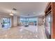 Bright living area with tile floors, fireplace, comfortable sofas, and expansive windows with view at 2850 Thunder Bay Ave, Henderson, NV 89052