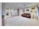 Bright living room with neutral walls, plush carpeting, and a comfortable leather sofa at 2850 Thunder Bay Ave, Henderson, NV 89052