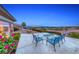 Back patio featuring mature landscape, concrete patio, views of the valley, and wrought iron furniture at 2850 Thunder Bay Ave, Henderson, NV 89052