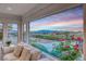 Breathtaking sunset views from the living room window with beautiful flowers at 2850 Thunder Bay Ave, Henderson, NV 89052