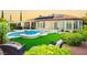 Lush backyard featuring pool, spa, covered patio, and comfortable seating area at 2859 Hayden Creek Ter, Henderson, NV 89052
