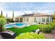 Beautiful backyard with pool, water feature, spa, artificial turf, and covered patio at 2859 Hayden Creek Ter, Henderson, NV 89052