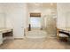 Bright bathroom features a soaking tub, glass-enclosed shower, and dual vanities at 2859 Hayden Creek Ter, Henderson, NV 89052