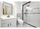 Modern bathroom with black framed glass shower and white vanity at 2859 Hayden Creek Ter, Henderson, NV 89052