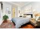 Comfortable bedroom featuring wood floors, soft lighting, and a cozy armchair at 2859 Hayden Creek Ter, Henderson, NV 89052