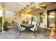 Relax on this covered patio with a ceiling fan, stone table, and outdoor kitchen area at 2859 Hayden Creek Ter, Henderson, NV 89052