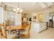 Bright eat-in kitchen area with tile floors, center island with granite counter, and stainless appliances at 2859 Hayden Creek Ter, Henderson, NV 89052