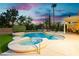 Beautiful backyard pool and spa with fountains, mature landscaping, and covered patio area at 2859 Hayden Creek Ter, Henderson, NV 89052