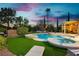 Inviting backyard oasis featuring a pool, spa, water feature and artificial turf at 2859 Hayden Creek Ter, Henderson, NV 89052