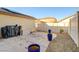 Backyard with desert landscaping, blue planters, and a white fence at 3232 Romanesque Art Ave, Henderson, NV 89044