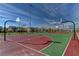 Outdoor basketball court with multiple hoops and colorful playing surface at 3232 Romanesque Art Ave, Henderson, NV 89044