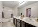 Bright bathroom with a double vanity, tub-shower combo, and modern fixtures at 3232 Romanesque Art Ave, Henderson, NV 89044