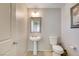 Bathroom featuring neutral walls, pedestal sink, and toilet at 3232 Romanesque Art Ave, Henderson, NV 89044