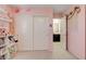 Pink accent bedroom featuring decorative floral accents, white storage, and sliding door closet at 3232 Romanesque Art Ave, Henderson, NV 89044