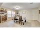 Bright dining room with tile floors, a dining table set for two, and natural light, creating an inviting atmosphere at 3232 Romanesque Art Ave, Henderson, NV 89044