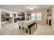 Open-concept dining area connecting to the kitchen, with tile flooring and a bench, ideal for Gathering meals and gatherings at 3232 Romanesque Art Ave, Henderson, NV 89044