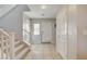 Bright foyer with tile flooring, a staircase, and a front door, creating an open and welcoming entrance to the home at 3232 Romanesque Art Ave, Henderson, NV 89044