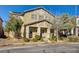 Attractive two-story home featuring meticulous landscaping and a welcoming front entrance with a blue door and a comfortable porch at 3232 Romanesque Art Ave, Henderson, NV 89044