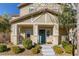 Inviting front porch with a blue door, complemented by neat landscaping and a cozy entrance for a warm welcome at 3232 Romanesque Art Ave, Henderson, NV 89044