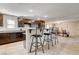 Spacious kitchen with dark wood cabinets, granite countertops, and a kitchen island with seating at 3232 Romanesque Art Ave, Henderson, NV 89044