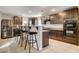 Beautiful kitchen with dark wood cabinets, granite countertops, and stainless steel refrigerator at 3232 Romanesque Art Ave, Henderson, NV 89044