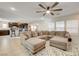 Open-concept living room with a sectional sofa, seamlessly connecting to the kitchen, perfect for entertaining and Gathering gatherings at 3232 Romanesque Art Ave, Henderson, NV 89044