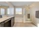 Main bathroom featuring double sinks with light countertops, and a glass-enclosed shower at 3232 Romanesque Art Ave, Henderson, NV 89044