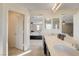 Main bathroom with double sinks, quartz countertops, and a glass-enclosed shower at 3232 Romanesque Art Ave, Henderson, NV 89044