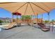 Covered playground with slides, climbing structures, and soft flooring at 3232 Romanesque Art Ave, Henderson, NV 89044