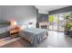 Spacious bedroom featuring a fireplace, modern tile flooring, and natural light from the backyard at 3306 Brookfield Dr, Las Vegas, NV 89120