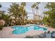 A resort-style pool area with lounge chairs offering residents a relaxing oasis surrounded by mature trees at 3306 Brookfield Dr, Las Vegas, NV 89120