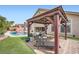 Backyard sitting area with chairs, a gazebo, and a pool at 3728 Granada Gorge Ln, North Las Vegas, NV 89084