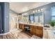 This bathroom features a double sink vanity, a shower, and a large mirror at 3728 Granada Gorge Ln, North Las Vegas, NV 89084