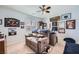 This is a bedroom with a ceiling fan, a large window, carpet, and decorated walls at 3728 Granada Gorge Ln, North Las Vegas, NV 89084