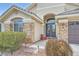 Welcoming single-story home with stone accents, a three-car garage, desert landscaping, and paved walkway at 3728 Granada Gorge Ln, North Las Vegas, NV 89084