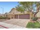 Attractive single-story home featuring a three-car garage with paver driveway and manicured desert landscaping at 3728 Granada Gorge Ln, North Las Vegas, NV 89084
