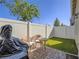 Cozy backyard with artificial grass, patio, BBQ, and privacy fencing at 3783 Canis Minor Ln # 6104, Henderson, NV 89052