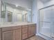 Bathroom with double sink vanity, large mirror, and walk-in glass shower at 3783 Canis Minor Ln # 6104, Henderson, NV 89052
