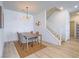 Dining room with a modern chandelier, seating for four, and stairs leading to upper level at 3783 Canis Minor Ln # 6104, Henderson, NV 89052