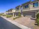 A row of modern townhomes with well-kept front yard landscaping and private garages at 3783 Canis Minor Ln # 6104, Henderson, NV 89052