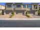 Townhome exterior features multiple garages, desert landscaping and visible unit numbers at 3783 Canis Minor Ln # 6104, Henderson, NV 89052